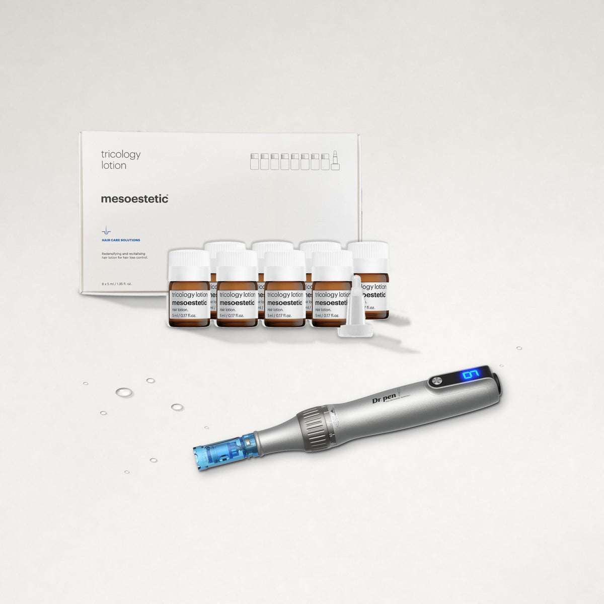 mesoestetic tricology lotion box and vials with the Dr. Pen M8S on a warm white surface